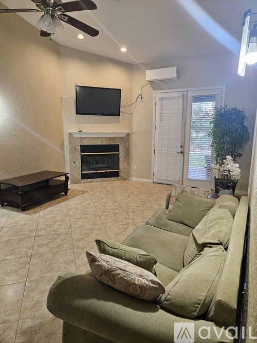 A bathroom with a large tub and a window with a view of trees.