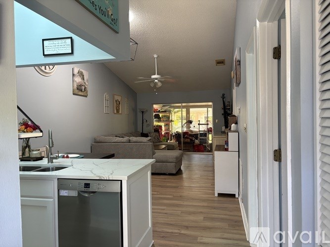 A kitchen with a white fridge and a white dishwasher.