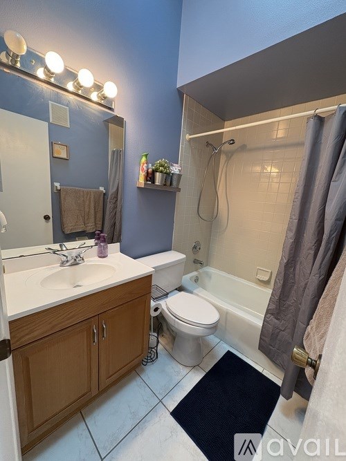 A bathroom with blue walls and a white sink.