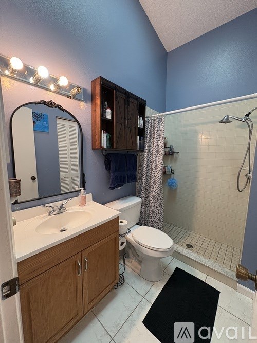 A bathroom with blue walls and a white sink.