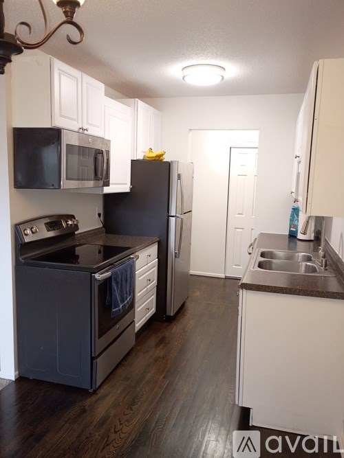 A kitchen with a black stove and a black refrigerator.
