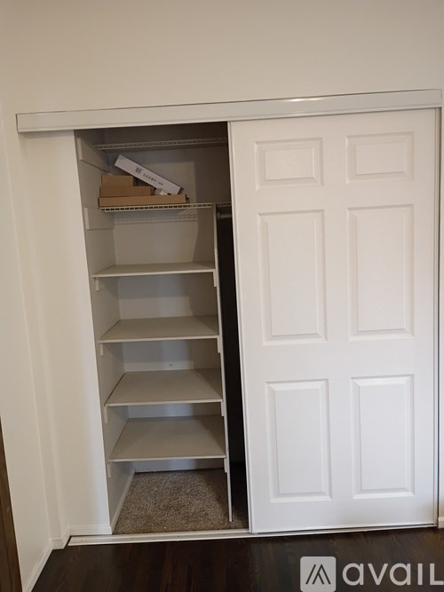 A white door with a shelf underneath it.