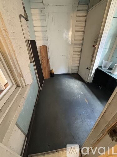 A room with a black floor and white walls.