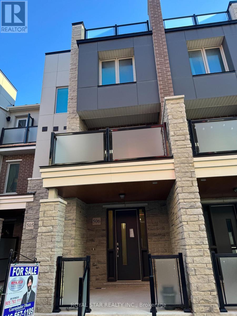 A multi-story building with a balcony and a "For Sale" sign in front.