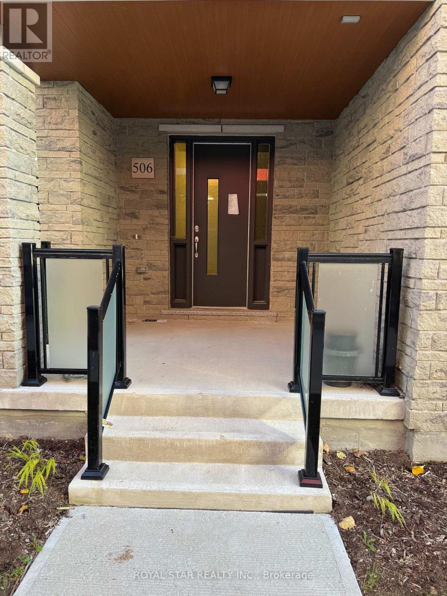 The entrance to a building with a glass door and a number 506 on the wall.