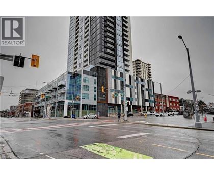 A city street with a REALTOR® sign on a building.