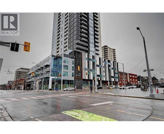 A city street with a REALTOR® sign on a building.