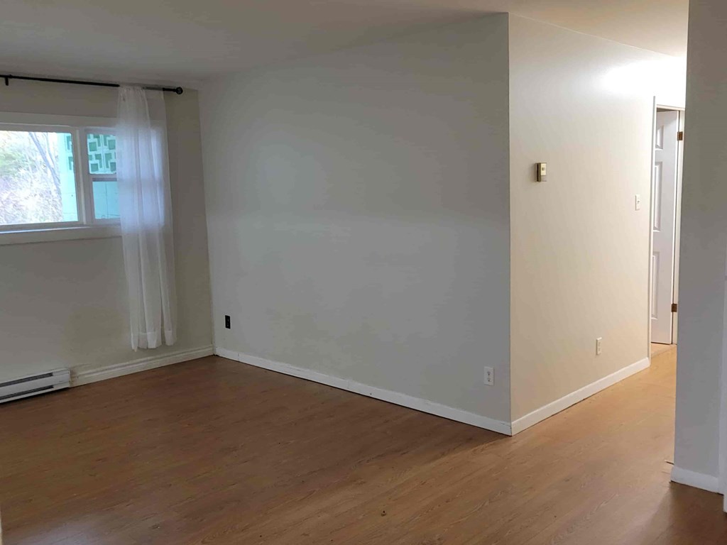 A room with wooden floors and white walls.