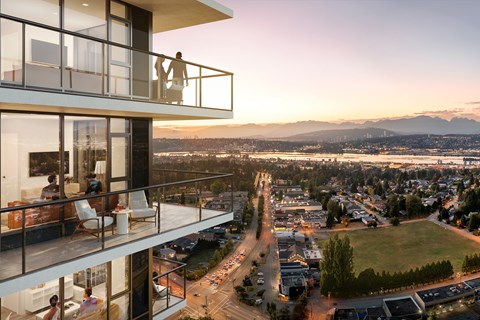 A balcony overlooks a cityscape at sunset.