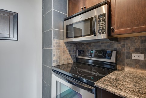 A modern kitchen with a stove and microwave.