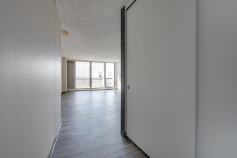 A long hallway with a door on the right.