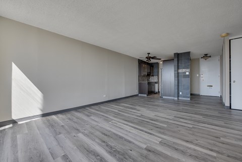 A room with a wooden floor and white walls.