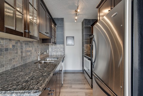 A modern kitchen with a stainless steel refrigerator.