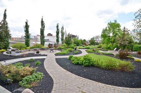 A garden with a circular pathway and a variety of plants.