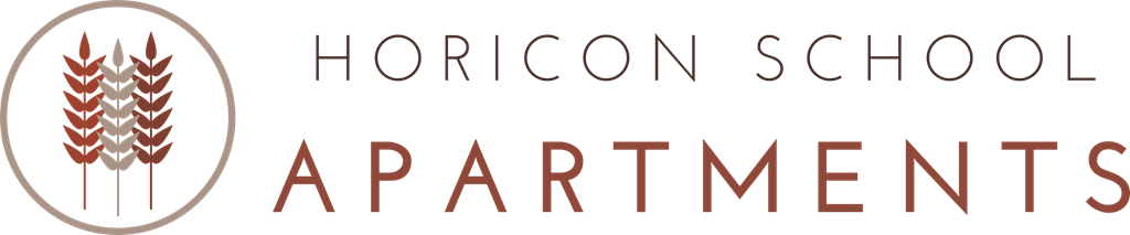 A sign for Horicon School Apartments featuring a wheat sheaf logo.