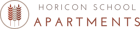 A sign for Horicon School Apartments featuring a wheat sheaf logo.