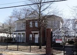 A brick house with a sign that says "Presbyterian" in front of it.