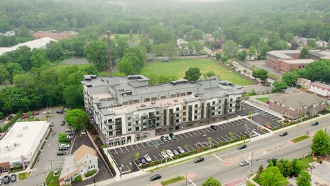 A large building with a parking lot in front of it.