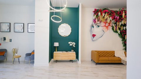 A room with a green wall and a large floral mural.