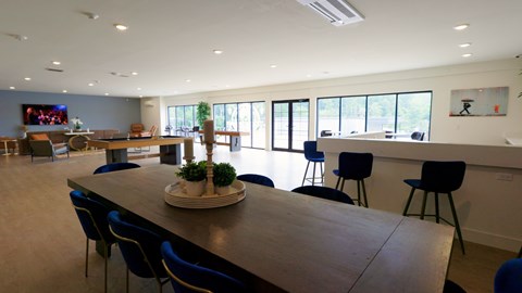 A conference room with a long table and chairs.