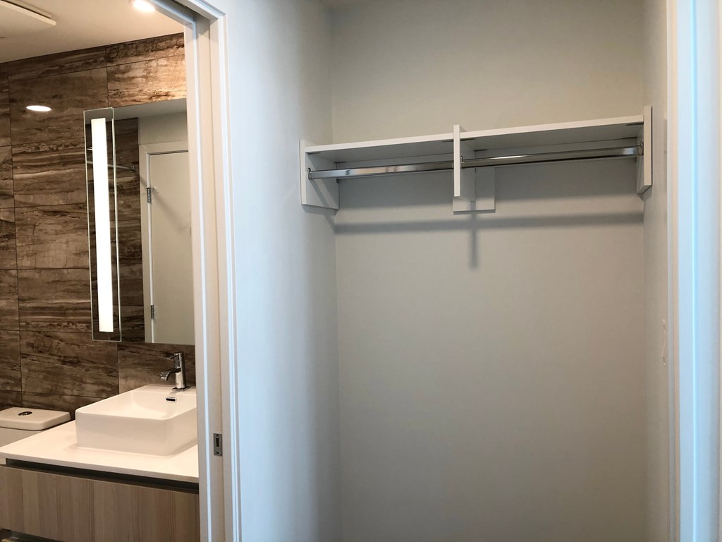 A bathroom with a white sink and a mirror.