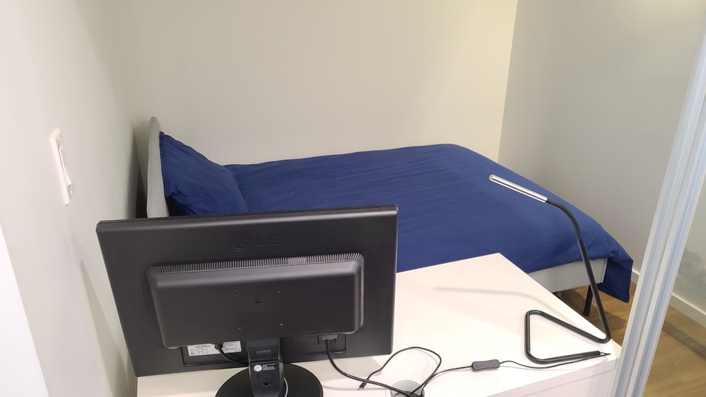 A computer monitor is placed on a white desk.