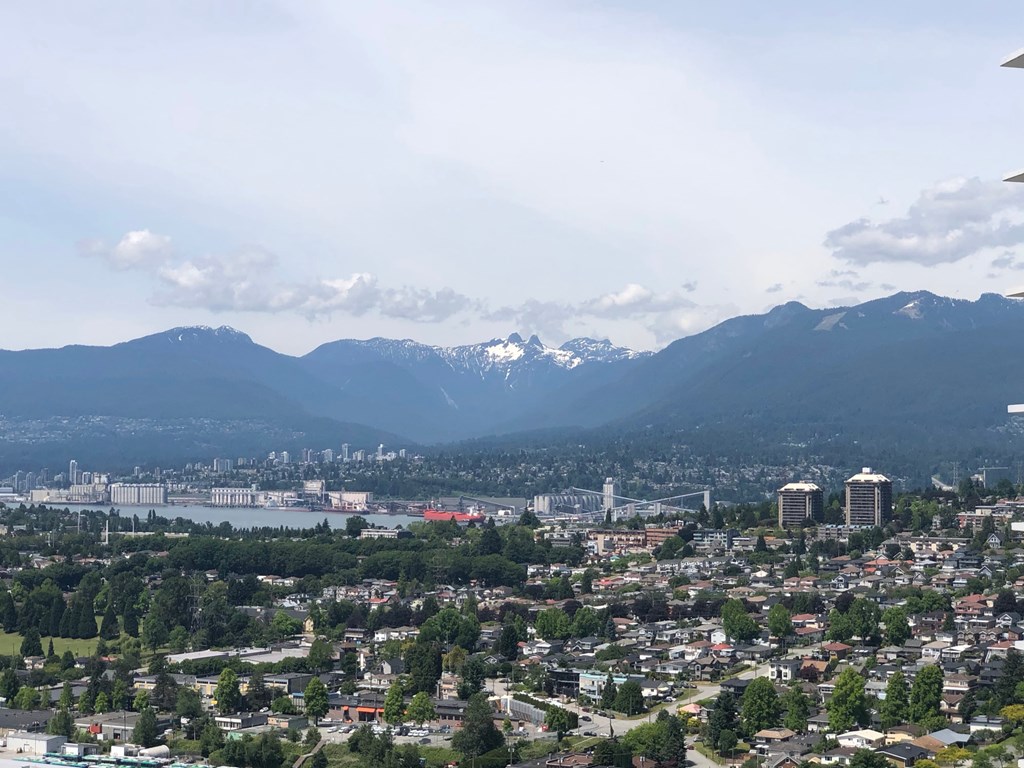 A cityscape with mountains in the background.