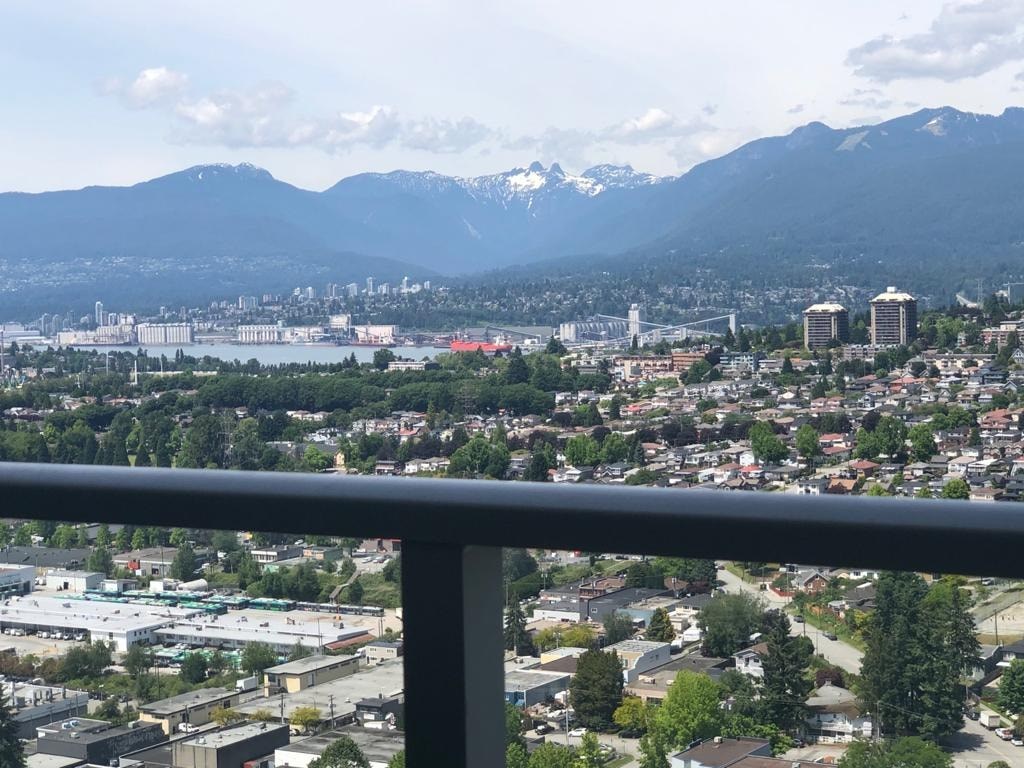 A cityscape with mountains in the background.