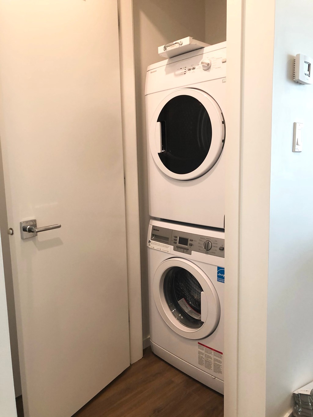 A white dryer and washer in a small laundry room.