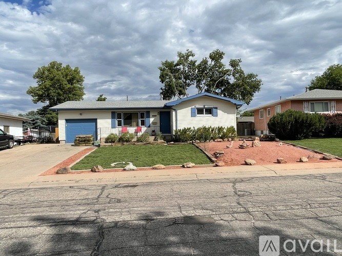 A house with a blue garage door is for sale.