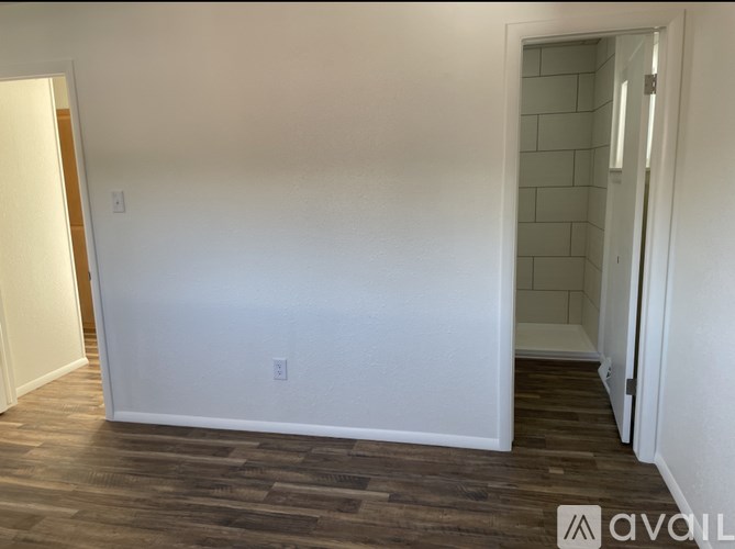 A room with a wooden floor and white walls.