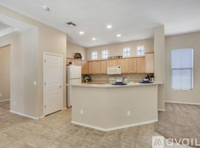 A kitchen area with a counter and cabinets is available for rent.