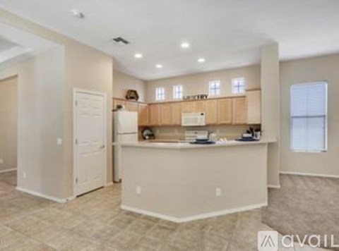 A kitchen area with a counter and cabinets is available for rent.