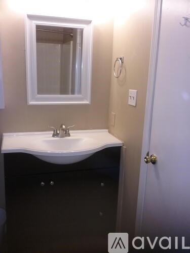 A bathroom with a sink and mirror.