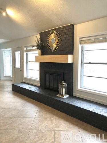 A fireplace with a sun design on the wall above it.