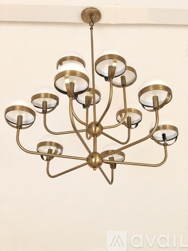A chandelier with a gold finish and multiple lights.