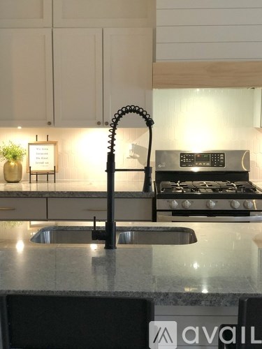 A kitchen with a stove and a sink.