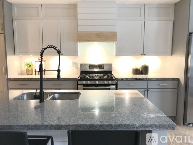 A kitchen with a granite countertop and a sink.