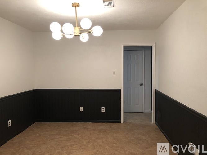 A room with a door and a light fixture.