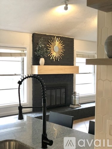 A kitchen with a black and white theme and a large window.