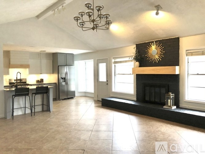 A modern kitchen with a dining area and a fireplace.