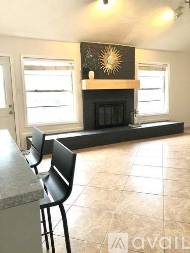 A black chair is in front of a marble countertop.