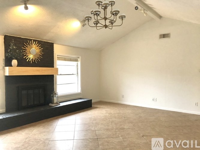 A room with a fireplace and a chandelier.