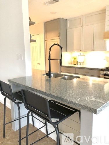A kitchen with a granite countertop and a sink.