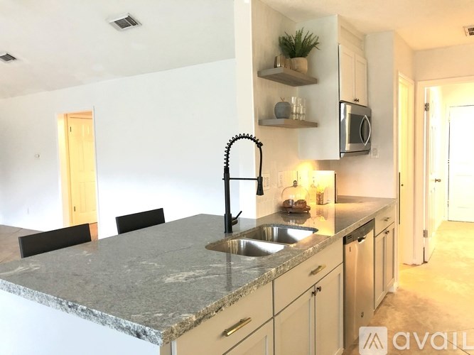 A kitchen with a granite countertop and a sink.