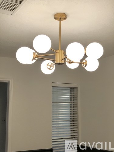 A chandelier with eight globes hangs from the ceiling.