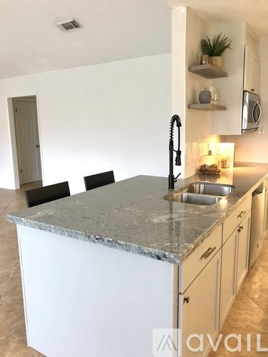 A kitchen with a granite countertop and a sink.