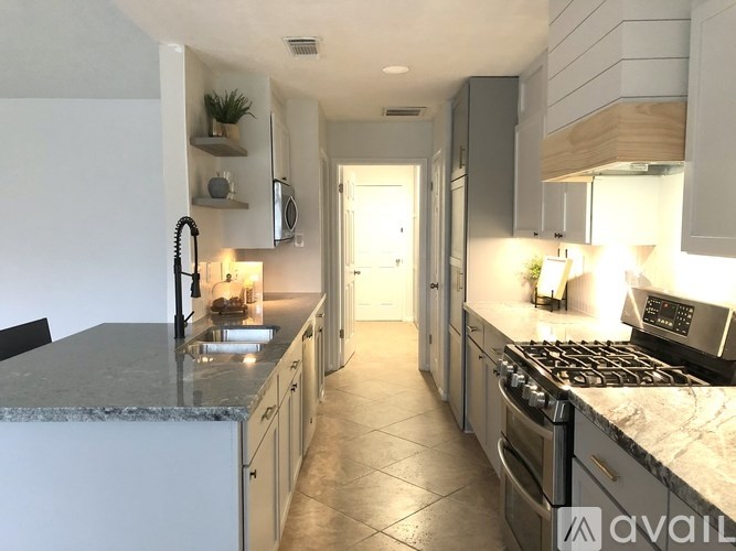 A kitchen with granite countertops and stainless steel appliances.