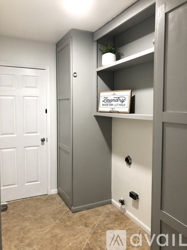 A grey storage unit with a sign that says "Laundry" on it.