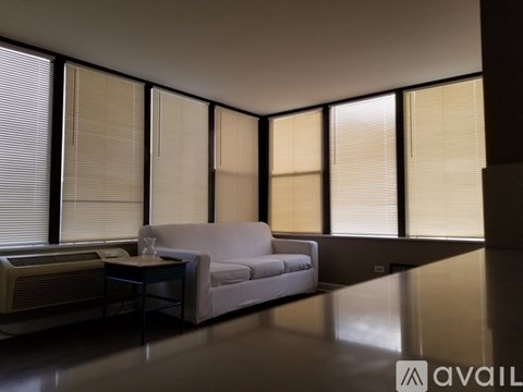 A modern living room with a white couch and a coffee table.